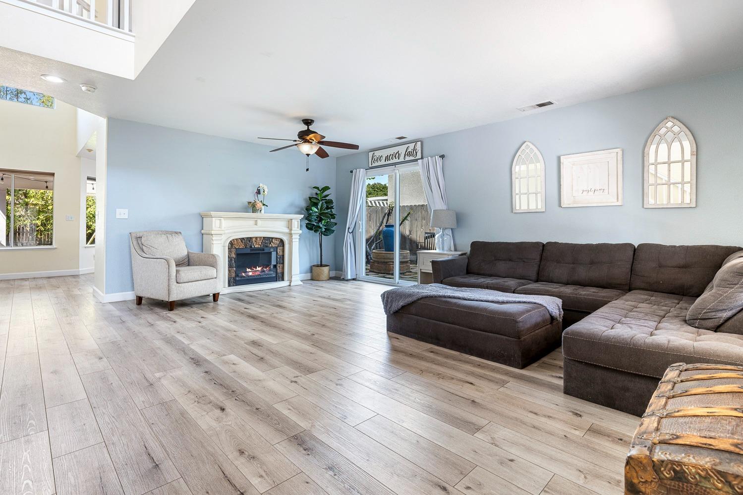 3232 Greenfield Avenue Clovis, CA 93611 - Photo 8 of 38 a living room with furniture and a fireplace