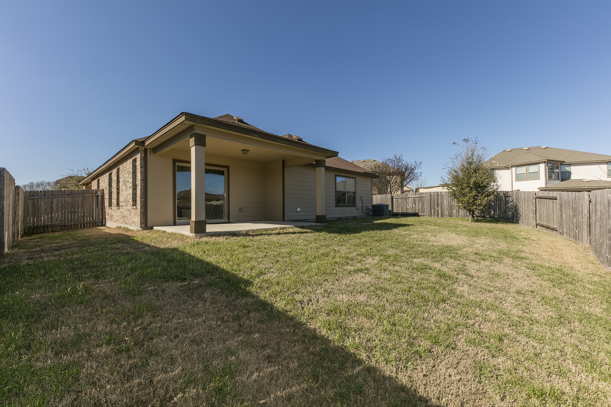 1141 Renaissance Trail Round Rock, TX 78665 - Photo 16 of 23 A spacious backyard with a private fence, featuring a covered patio for outdoor enjoyment.