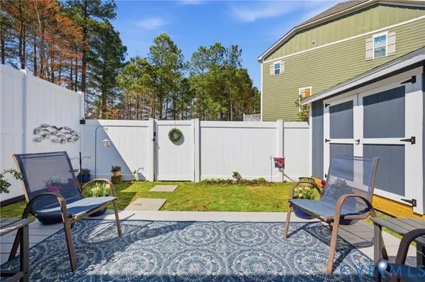 an aerial view of a house with swimming pool and outdoor seating