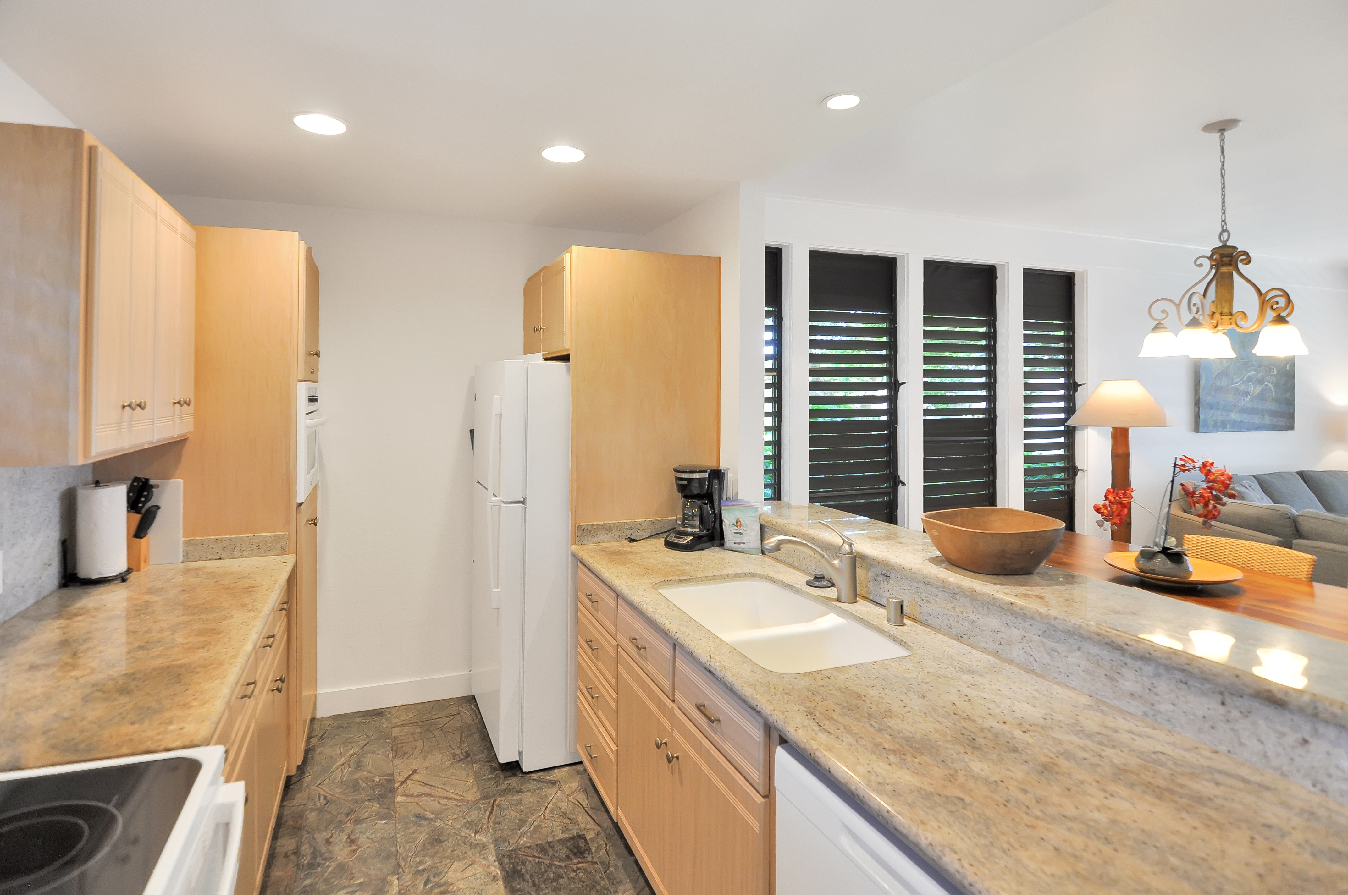 2253 Poipu Road, Unit 244 Koloa, HI 96756 - Photo 5 of 20 a bathroom with a granite countertop sink and a large mirror