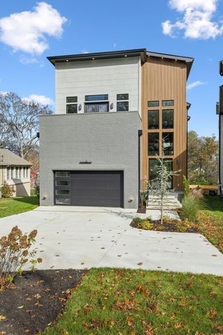 a view of a house with garden and sitting area