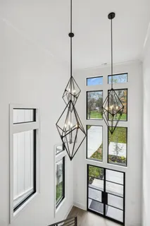 a balcony with wooden floor table and chairs