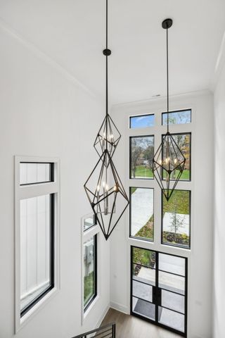 a balcony with wooden floor table and chairs
