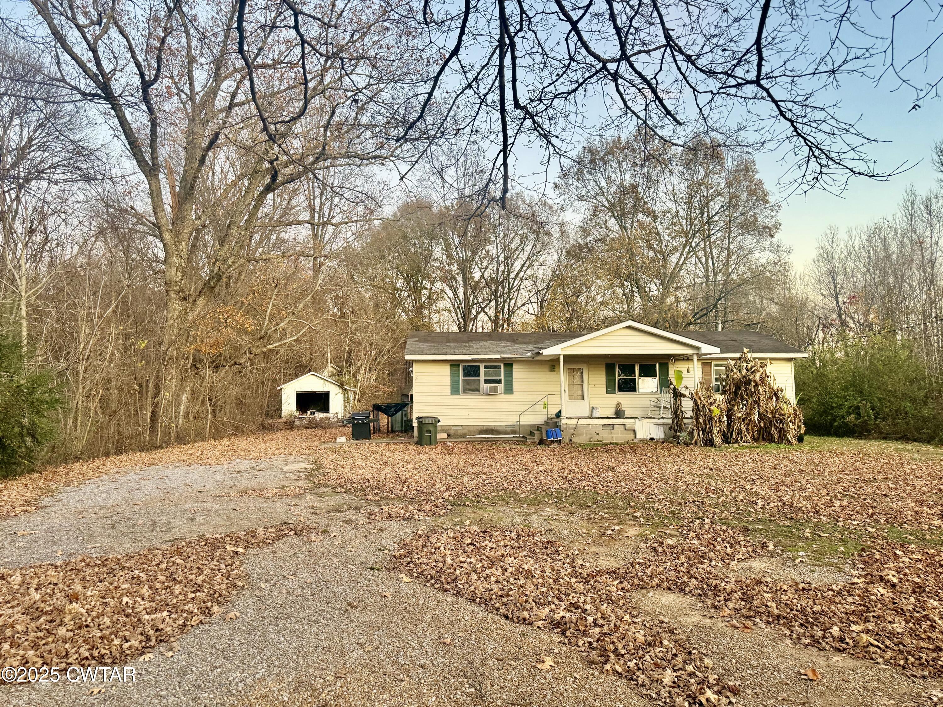 a wooden house with trees in front of it