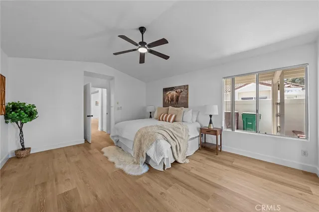 a bedroom with a bed and a potted plant