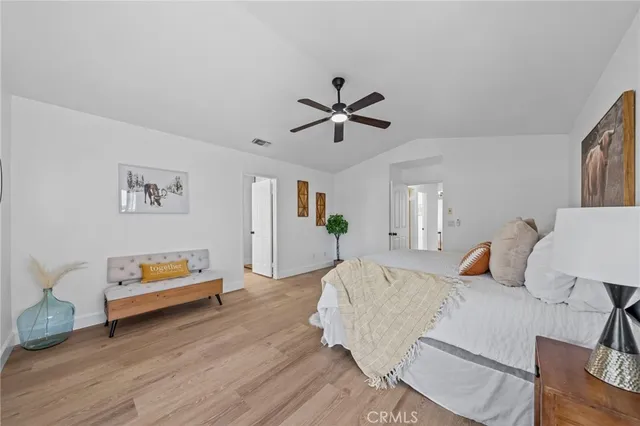 a bedroom with furniture and wooden floor