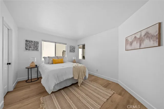 a bedroom with a bed and wooden floor