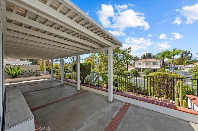 a view of a porch with furniture and garden