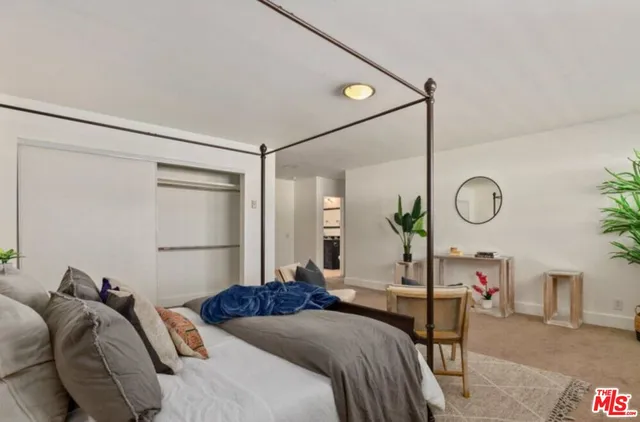 a bed room with a bed and a mirror