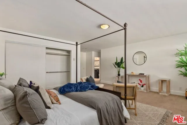 a bed room with a bed and a mirror