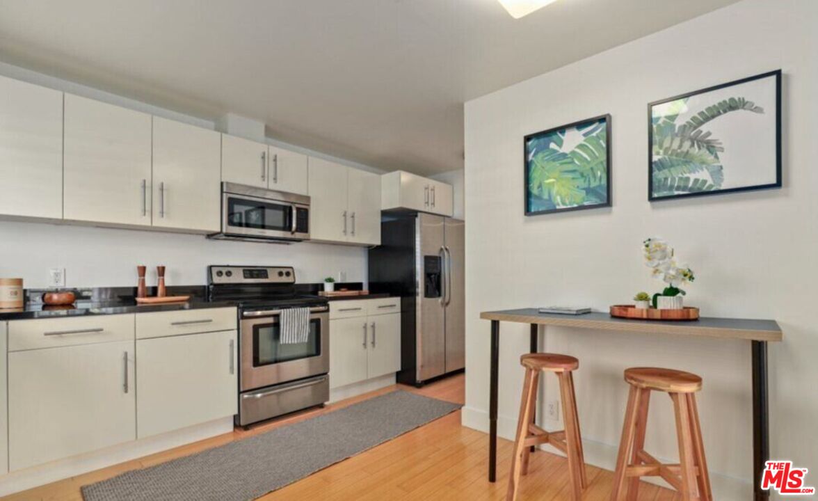 6624 South Springpark Avenue, Unit 5A Los Angeles, CA 90056 - Photo 9 of 23 a kitchen with stainless steel appliances granite countertop a refrigerator sink and stove
