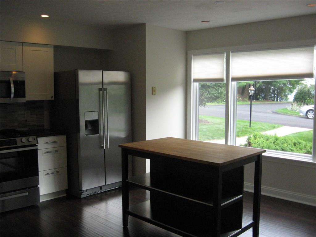 150 Shadow Ridge Drive Pittsburgh, PA 15238 - Photo 8 of 23 STAINLESS KITCHEN WHICH IS IN THE FRONT OF THE UNIT W/ISLAND & LARGE WINDOW - HW FLOORS