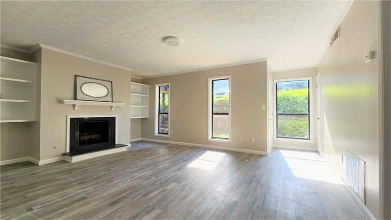401 Park Ridge Circle Marietta, GA 30068 - Photo 1 of 15 a view of an empty room with wooden floor fireplace and a window