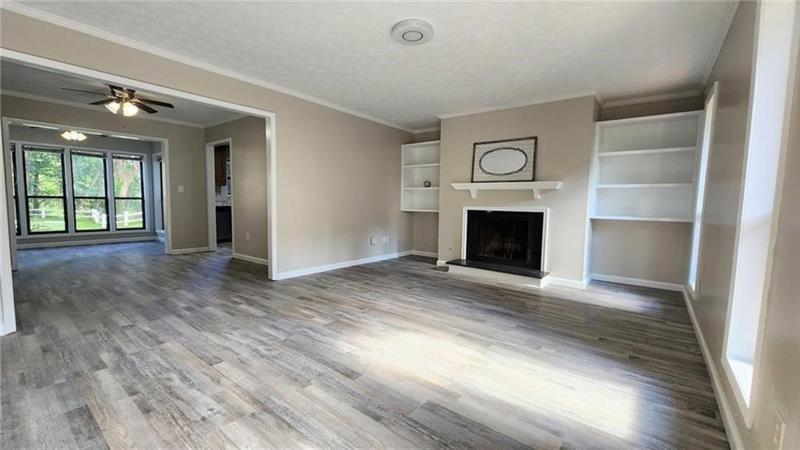 401 Park Ridge Circle Marietta, GA 30068 - Photo 3 of 15 a view of an empty room with wooden floor fireplace and a window