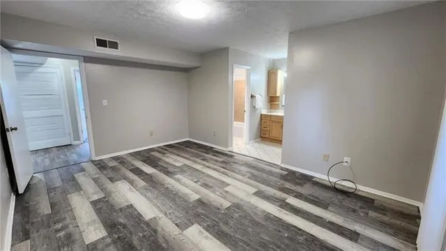a view of a room with wooden floor and bedroom
