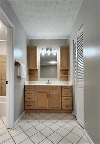 a bathroom with a sink vanity and mirror