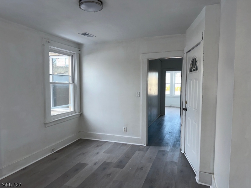 336 Broad Street, Unit 2 Bloomfield, NJ 07003 - Photo 6 of 24 a view of an empty room with wooden floor and a window