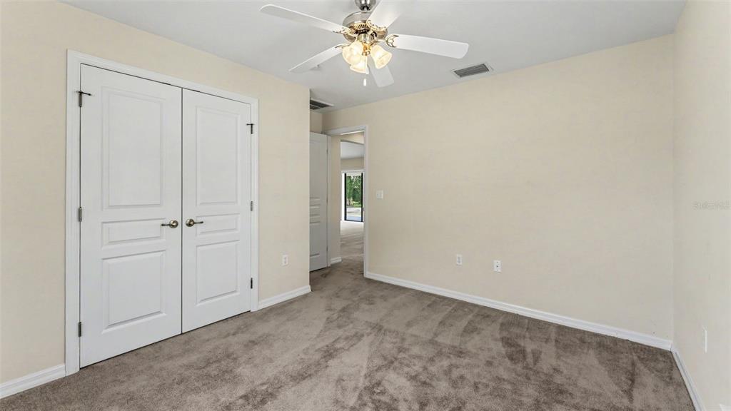 8525 North Campbell Road Lakeland, FL 33810 - Photo 15 of 45 an empty room with a ceiling fan and a window