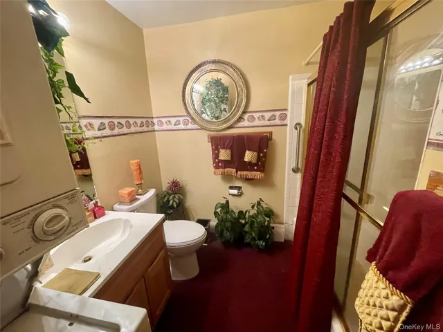 a bathroom with a toilet and a mirror