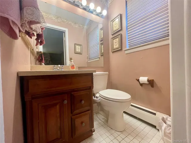 a bathroom with a sink a toilet and mirror