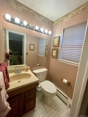 a bathroom with a sink mirror vanity and toilet