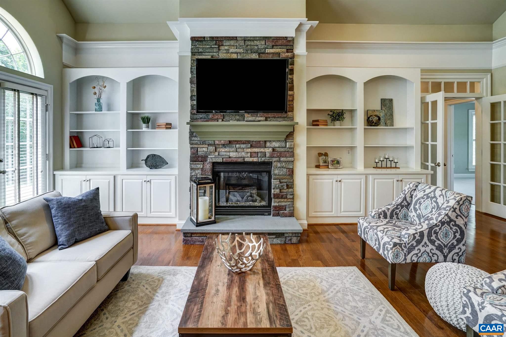 5327 Raven Stone Road Crozet, VA 22932 - Photo 17 of 67 a living room with furniture fireplace and flat screen tv