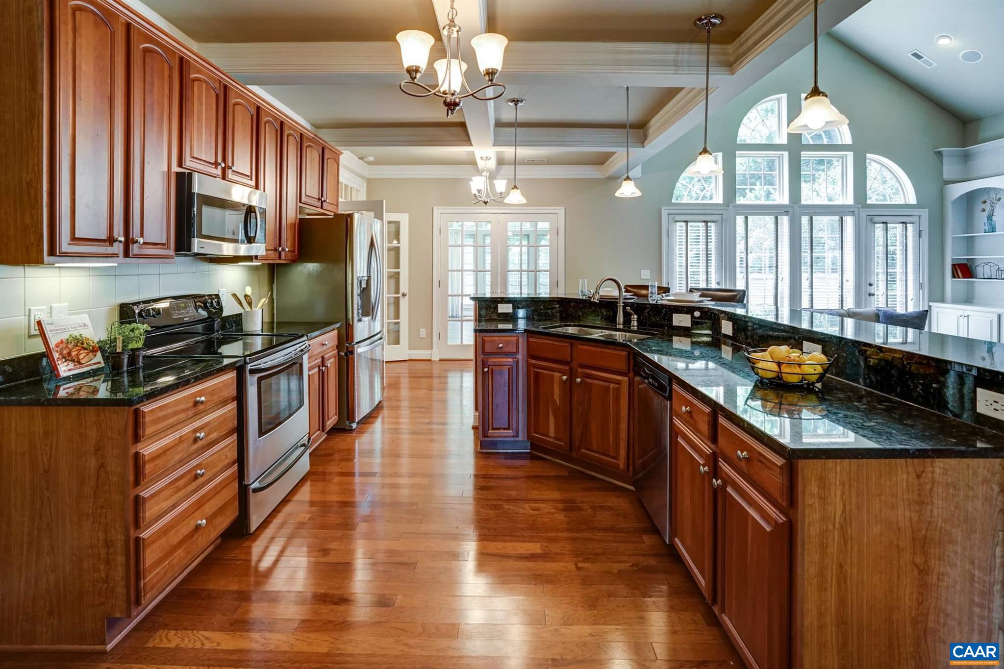 5327 Raven Stone Road Crozet, VA 22932 - Photo 23 of 67 a kitchen with stainless steel appliances granite countertop a stove a sink dishwasher and a microwave oven with large wooden cabinets