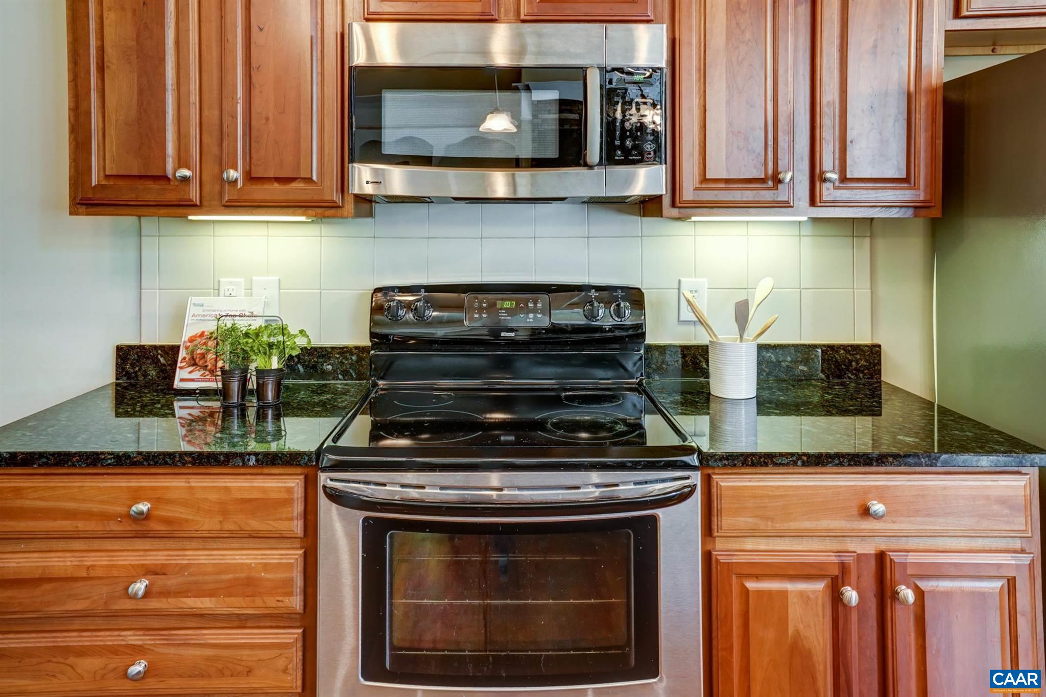 5327 Raven Stone Road Crozet, VA 22932 - Photo 26 of 67 a kitchen with granite countertop a stove and a microwave