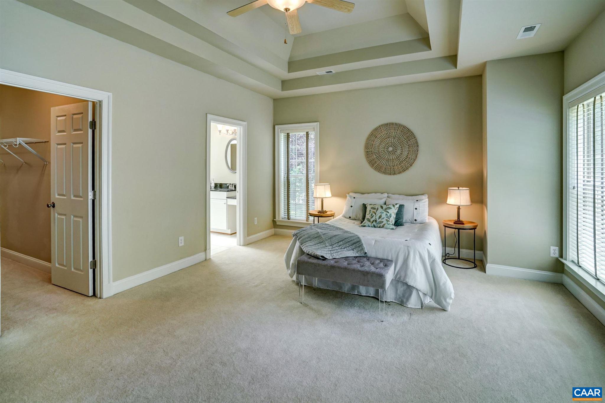 5327 Raven Stone Road Crozet, VA 22932 - Photo 31 of 67 a bedroom with a bed and a chandelier