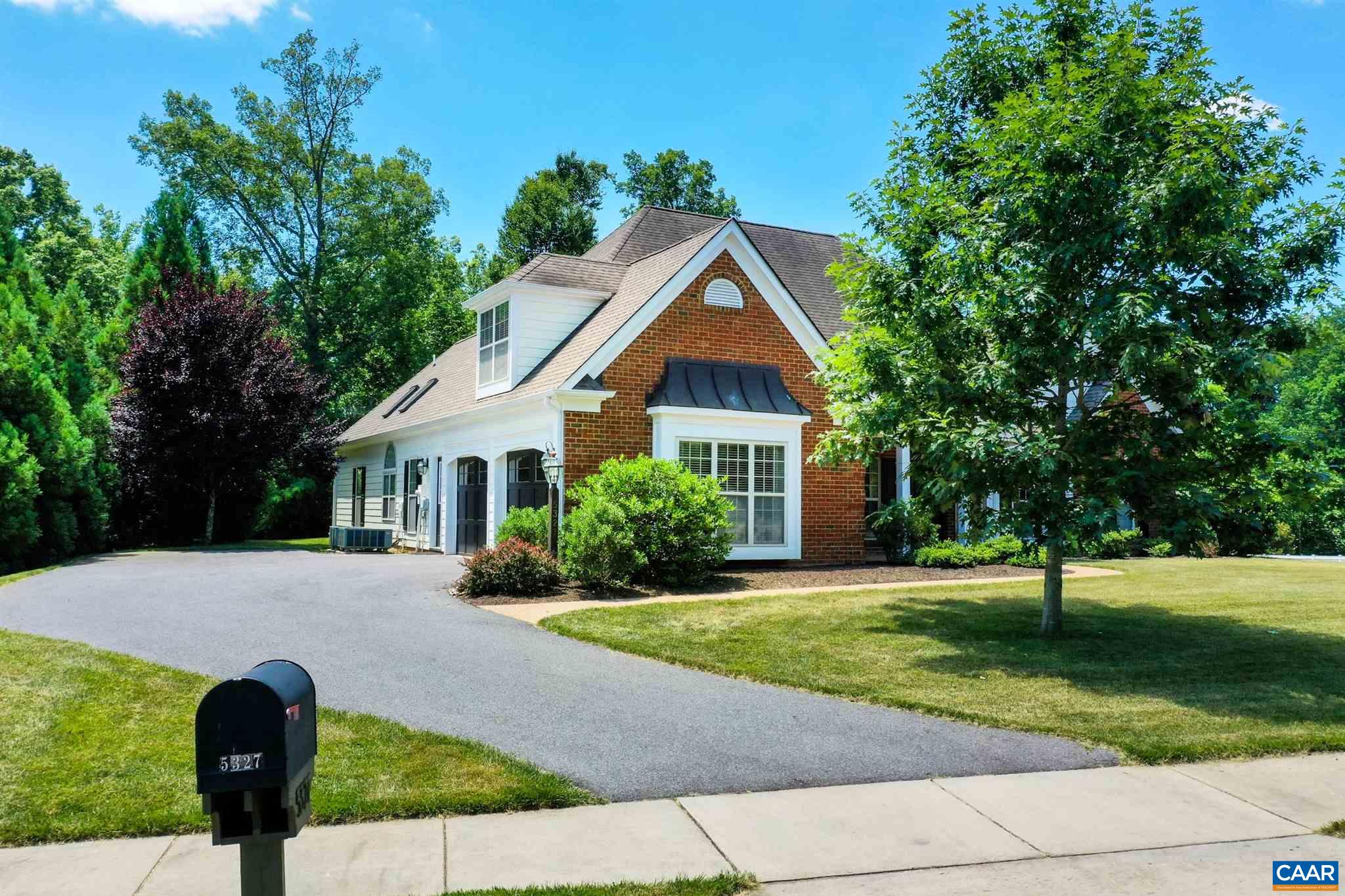 5327 Raven Stone Road Crozet, VA 22932 - Photo 51 of 67 a front view of a house with a yard and trees