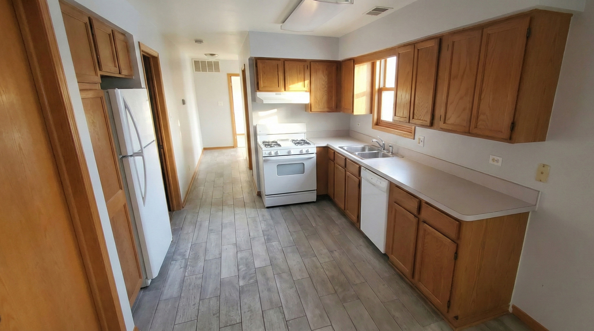 445 West 37th Street, Unit GARDEN Chicago, IL 60609 - Photo 2 of 9 a kitchen with stainless steel appliances granite countertop a refrigerator and wooden cabinets