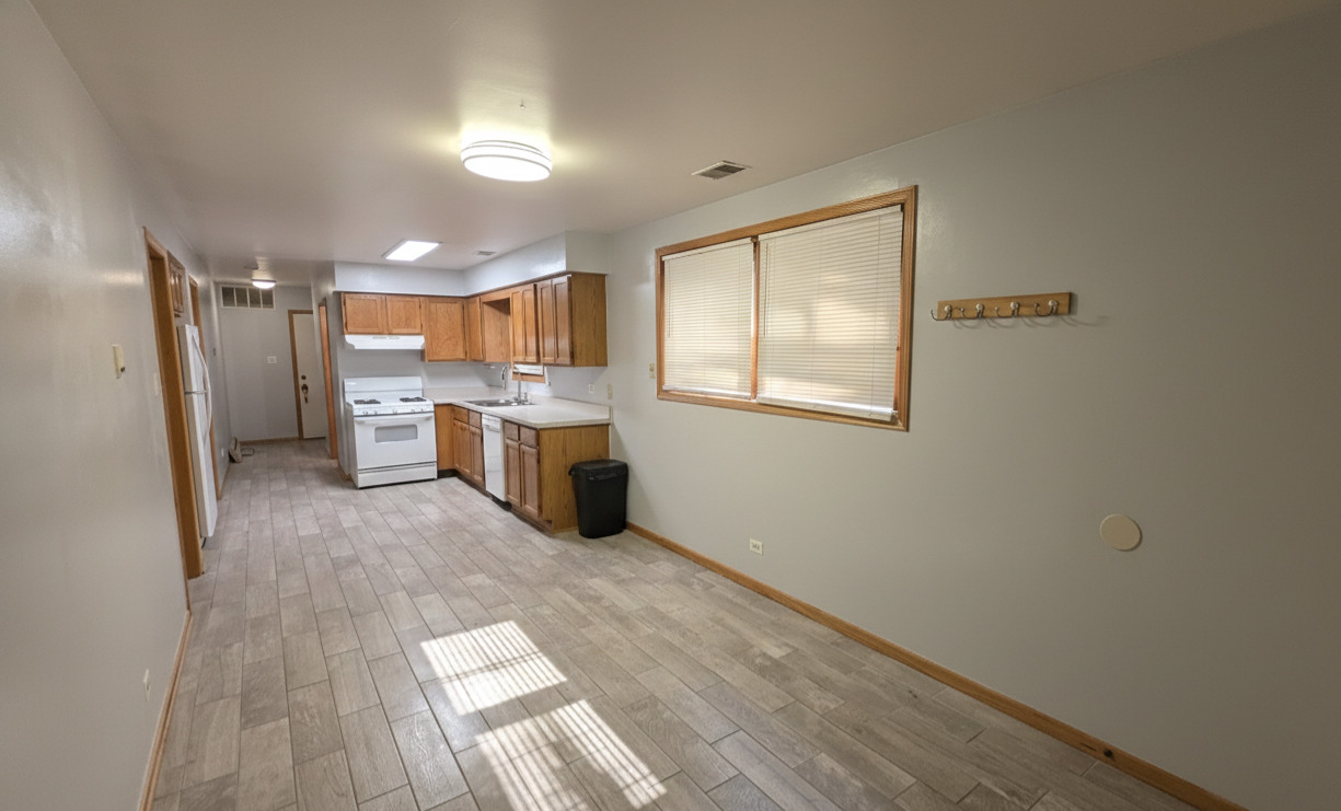 445 West 37th Street, Unit GARDEN Chicago, IL 60609 - Photo 3 of 9 a view of a kitchen with a sink refrigerator and wooden floor