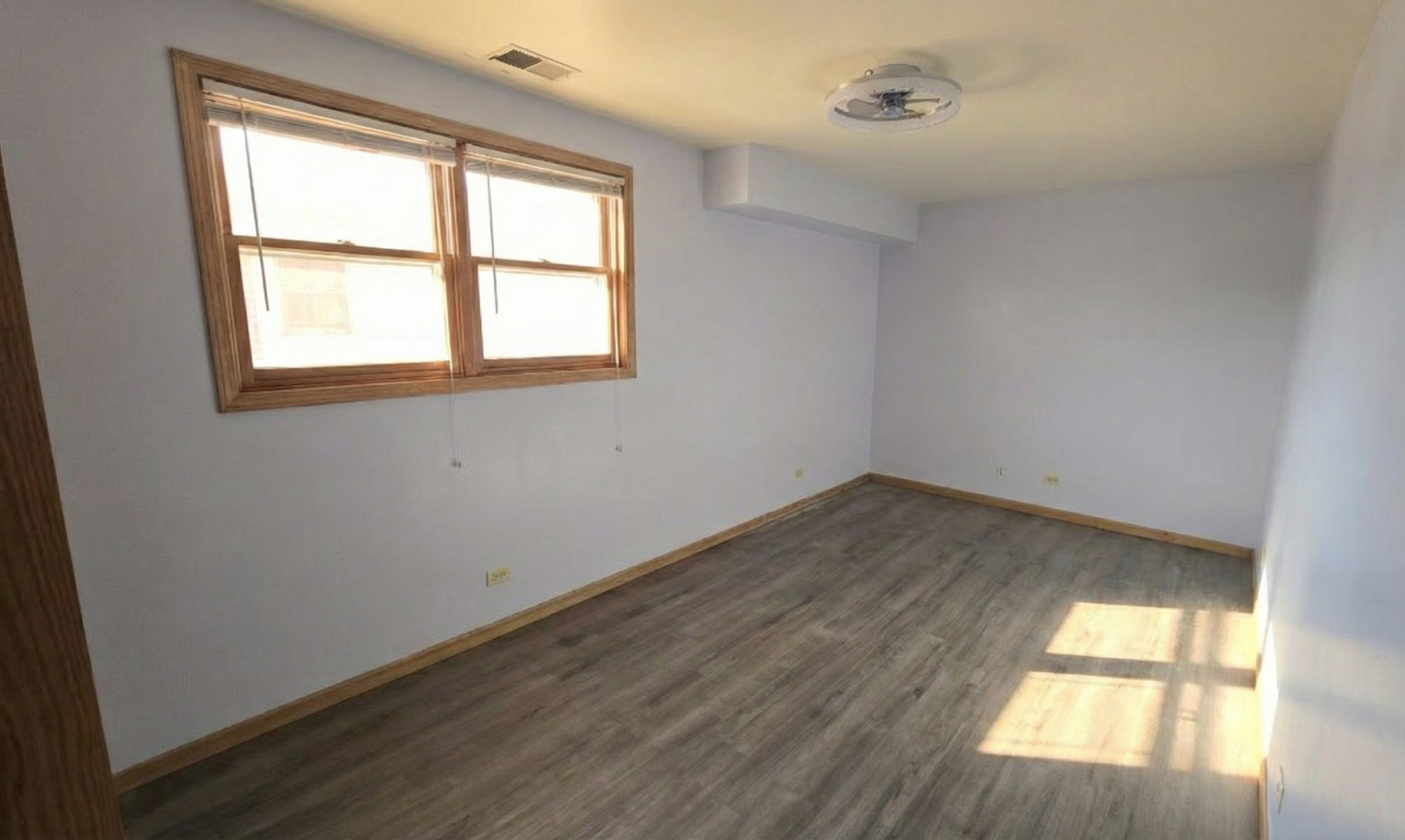 445 West 37th Street, Unit GARDEN Chicago, IL 60609 - Photo 9 of 9 an empty room with wooden floor and windows
