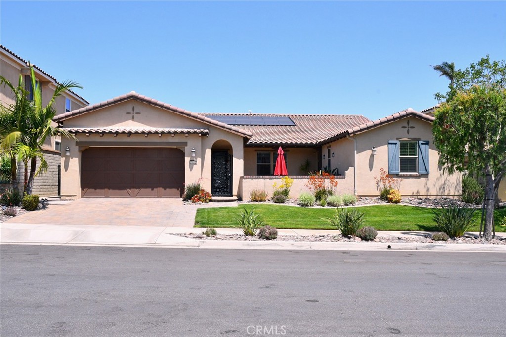 7612 Presidio Road Eastvale, CA 92880 - Photo 1 of 1 a front view of a house with a yard and garage
