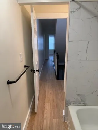 an empty room with wooden floor and a window