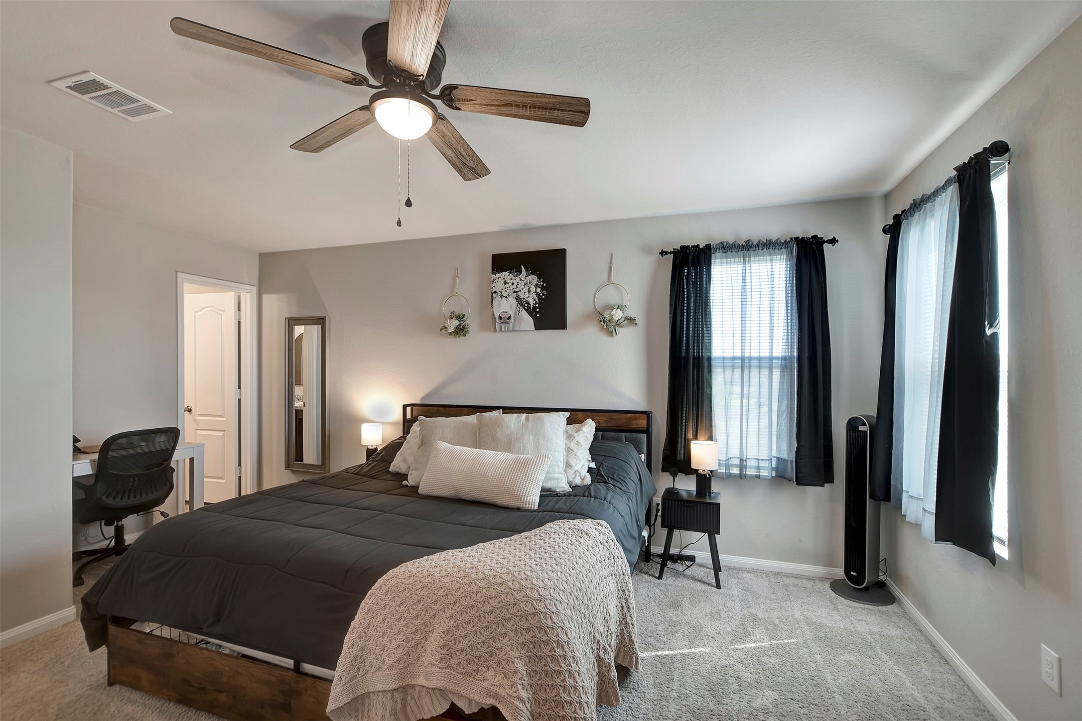 950 21st Street Hempstead, TX 77445 - Photo 21 of 35 a bedroom with a bed and a chandelier