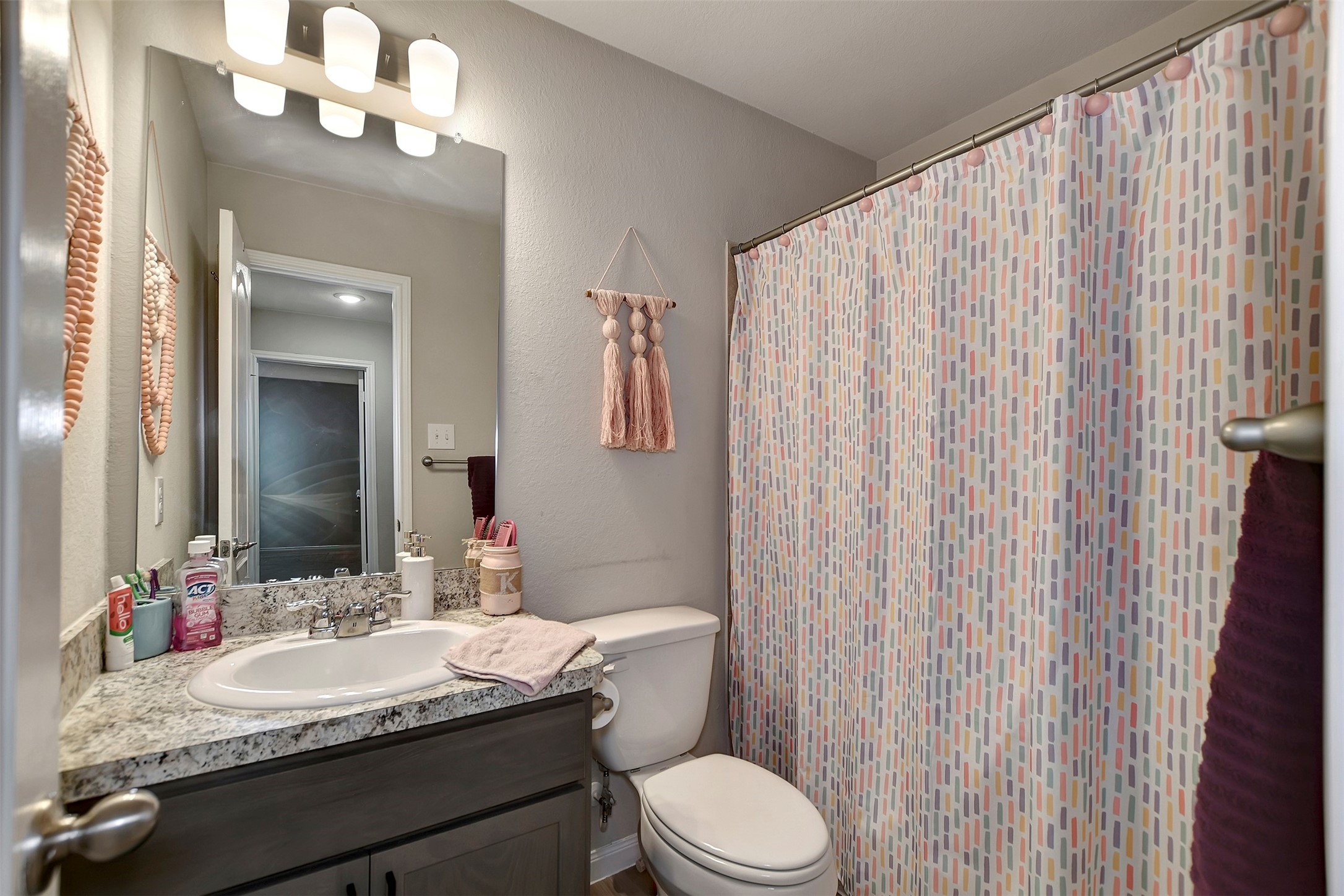 950 21st Street Hempstead, TX 77445 - Photo 27 of 35 a bathroom with a granite countertop sink vanity mirror and toilet
