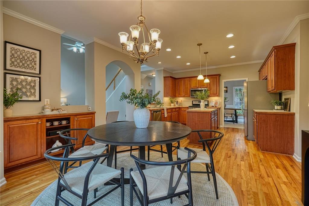 4555 Dennington Trace Cumming, GA 30028 - Photo 19 of 64 a view of a dining room with furniture and wooden floor