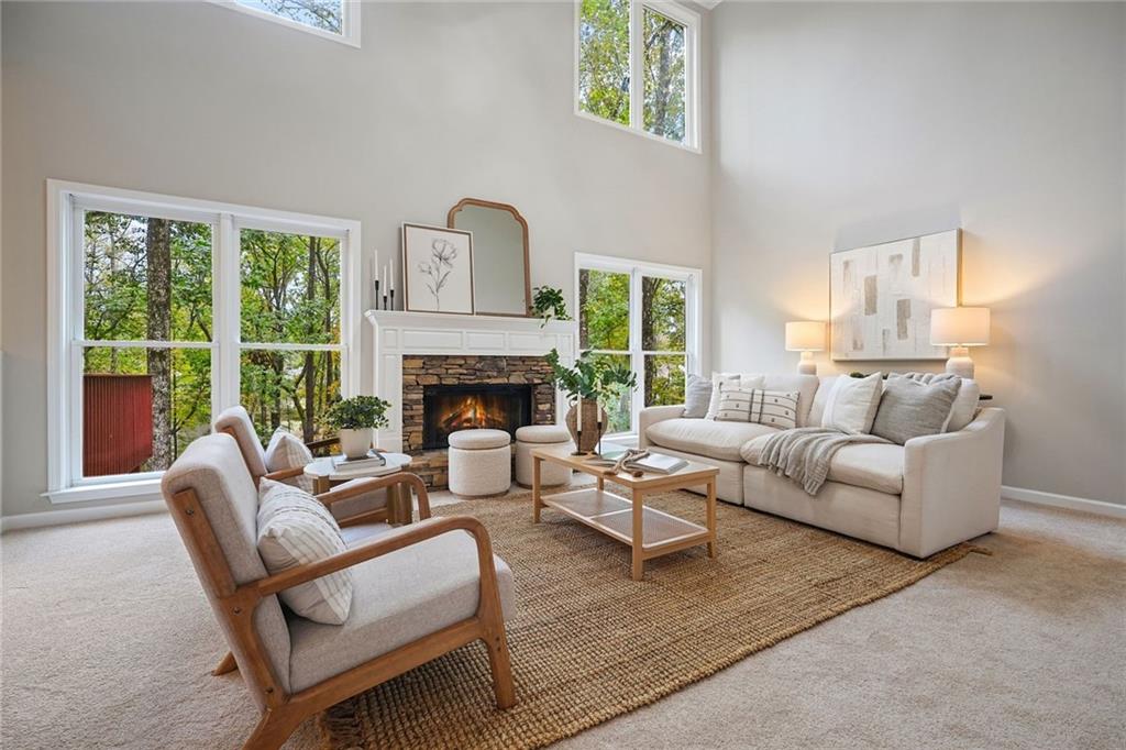 4555 Dennington Trace Cumming, GA 30028 - Photo 2 of 64 a living room with furniture fireplace and a large window