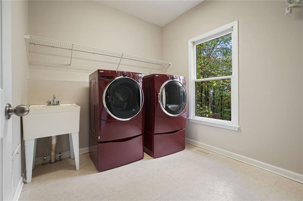 4555 Dennington Trace Cumming, GA 30028 - Photo 24 of 64 a utility room with dryer and washer