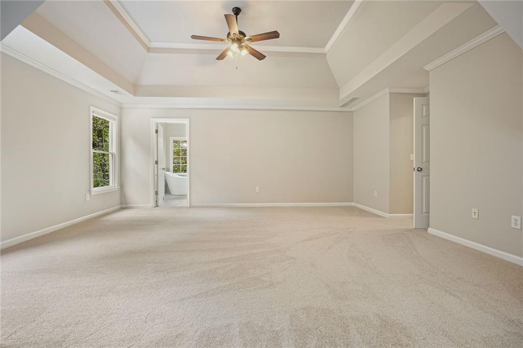 4555 Dennington Trace Cumming, GA 30028 - Photo 27 of 64 an empty room with chandelier fan and windows