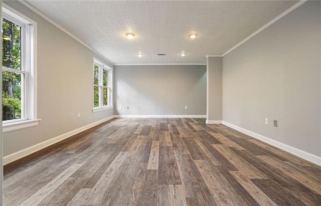 4555 Dennington Trace Cumming, GA 30028 - Photo 42 of 64 a view of empty room with wooden floor and fan