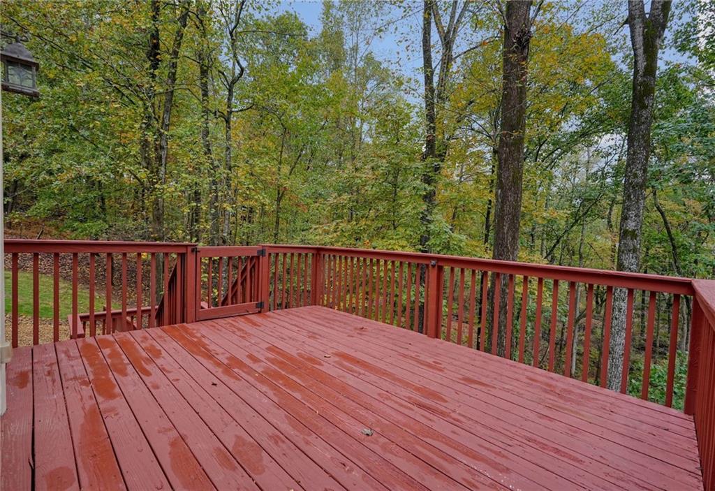 4555 Dennington Trace Cumming, GA 30028 - Photo 46 of 64 a balcony with wooden floor and trees