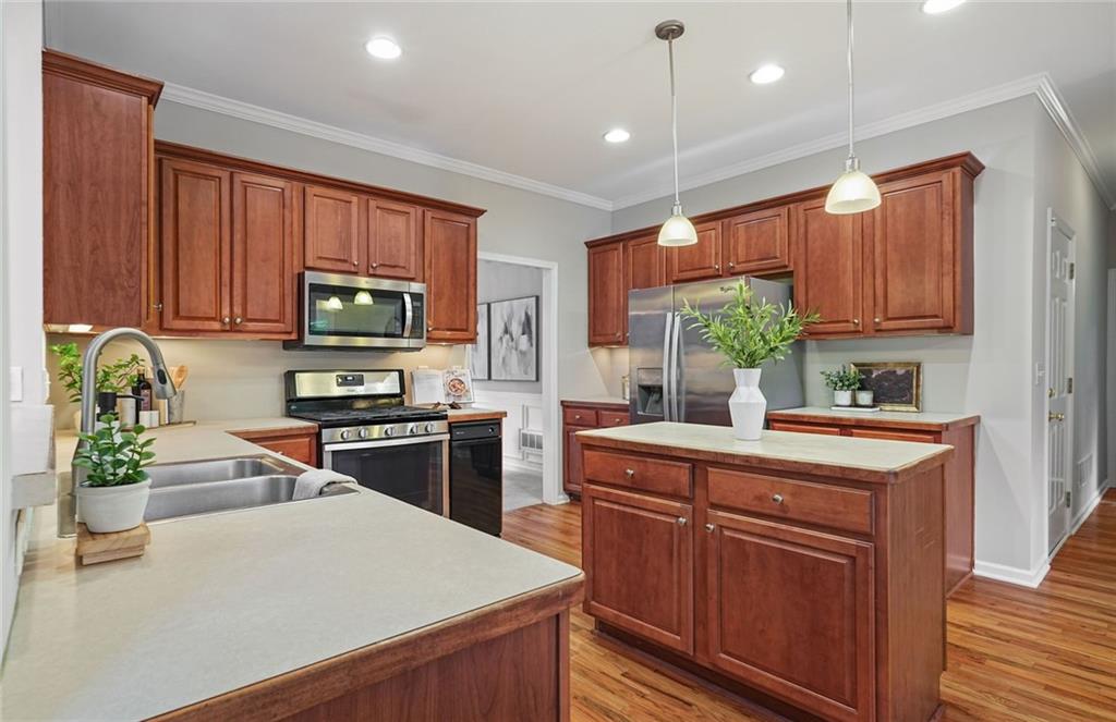 4555 Dennington Trace Cumming, GA 30028 - Photo 5 of 64 a kitchen with a sink a stove and cabinets