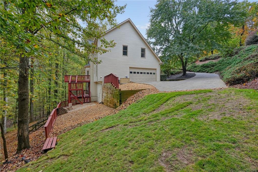 4555 Dennington Trace Cumming, GA 30028 - Photo 54 of 64 a view of a house with backyard and a tree