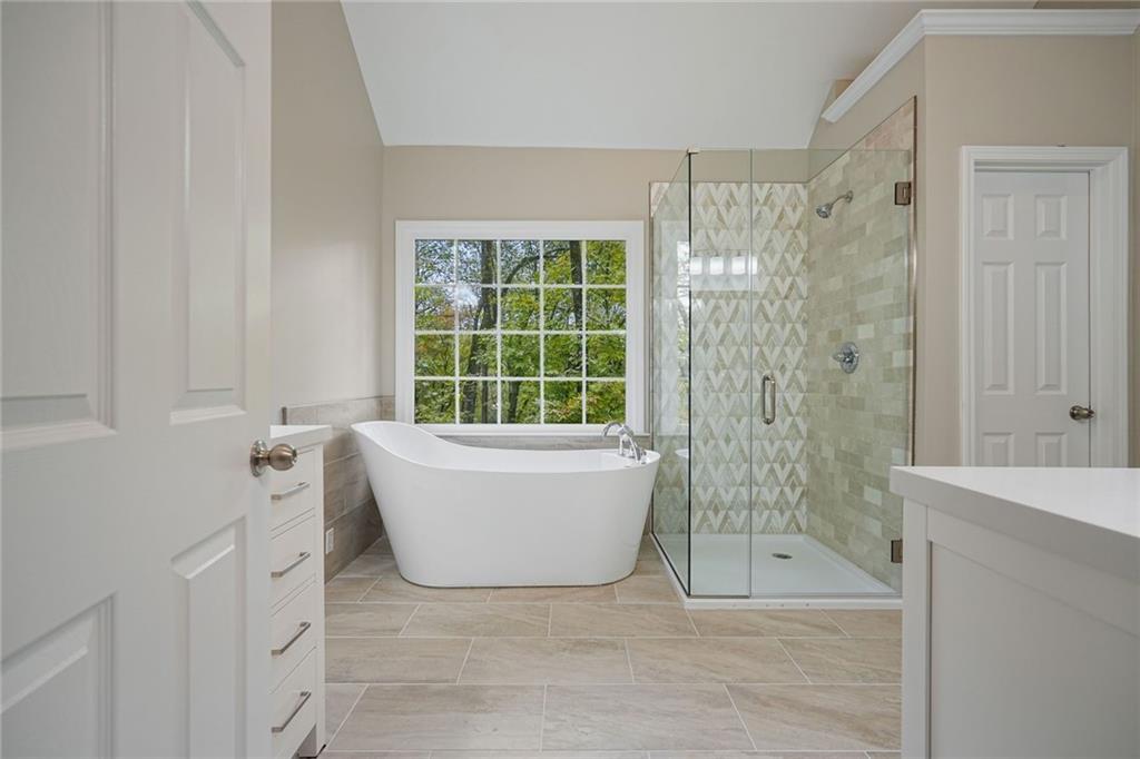 4555 Dennington Trace Cumming, GA 30028 - Photo 6 of 64 a bathroom with a bathtub and shower