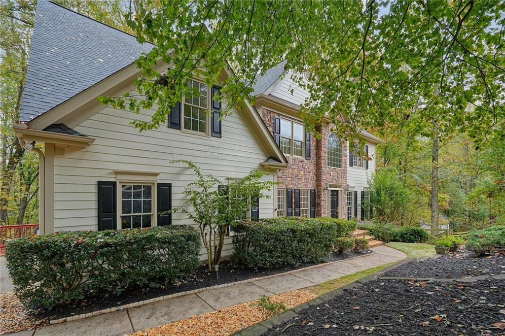 4555 Dennington Trace Cumming, GA 30028 - Photo 7 of 64 a front view of a house with garden