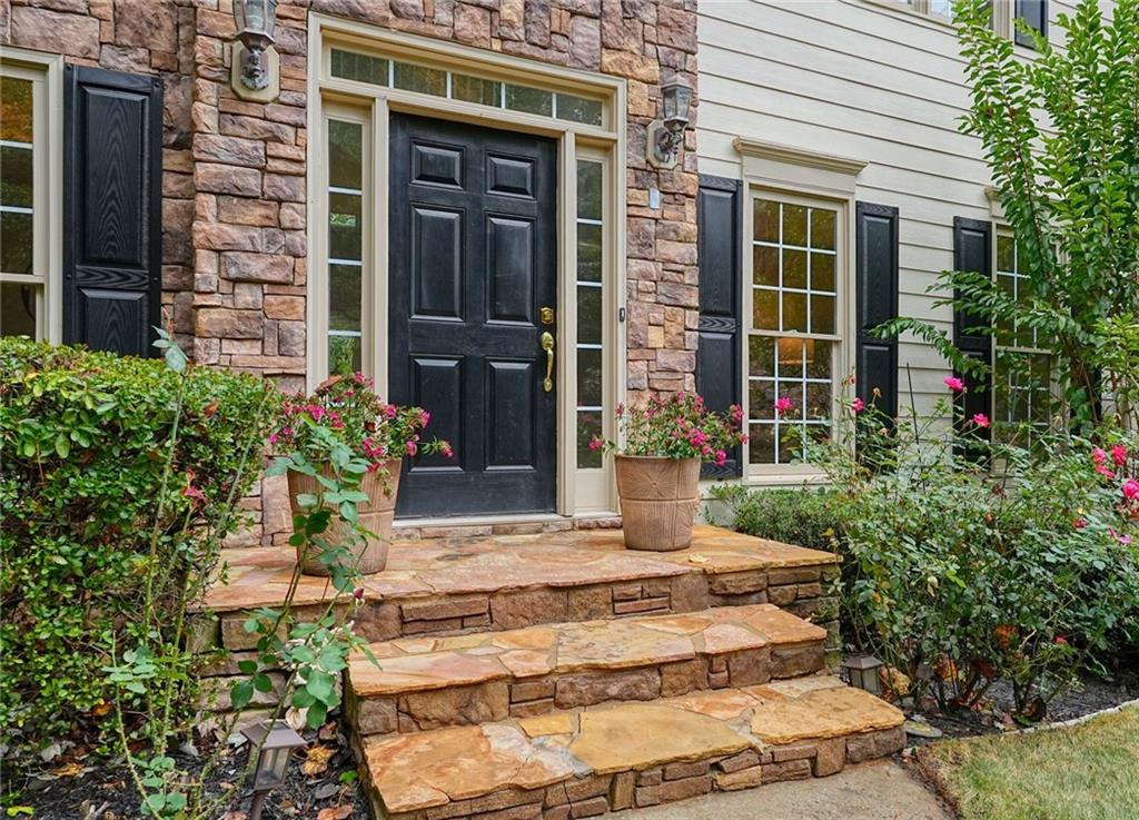 4555 Dennington Trace Cumming, GA 30028 - Photo 8 of 64 a view of a house with potted plants