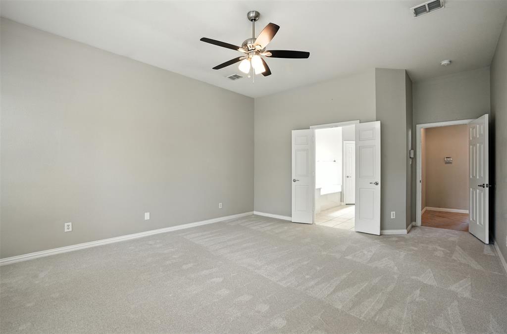 8220 Holliday Road Lantana, TX 76226 - Photo 19 of 40 Spacious room featuring vaulted ceilings, light gray wall tones, and carpet flooring