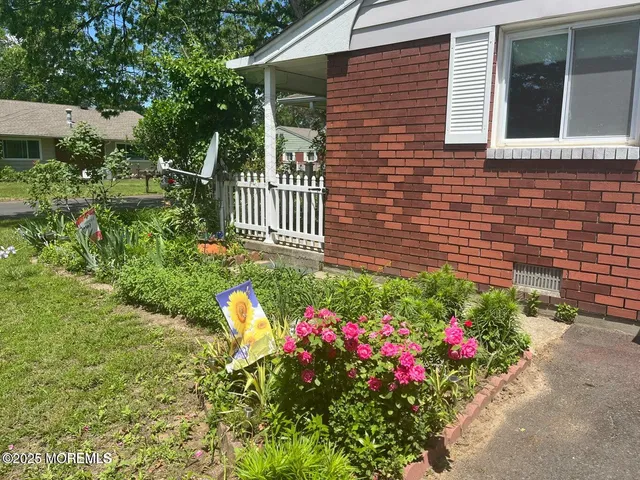 a front view of a house with a yard and fountain